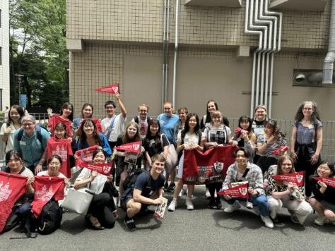 Students and faculty pose with W&J flags in Japan.